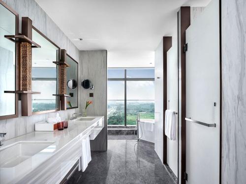 徐州徐州伊敦康得思酒店的一间带两个盥洗盆的浴室和一个大窗户
