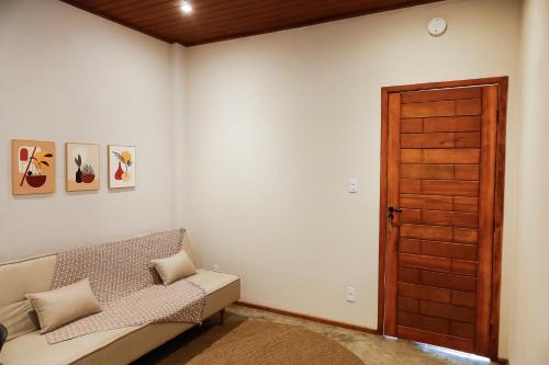 彼得罗波利斯Vista do Vale lofts - Itaipava的带沙发和木门的客厅