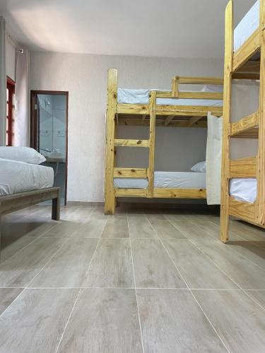 卡诺格布拉达Espaço conforto e tranquilidade CASAVEG的一间带两张双层床的卧室,铺有瓷砖地板。