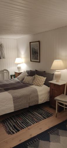 普赖斯特Fuglsanggaard. Private annex in nature.的一间卧室配有一张带两盏灯和地毯的床。