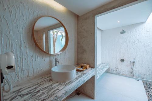 格兰岛Myth Koh Larn resort bar and bistro的一间带圆形水槽和镜子的浴室