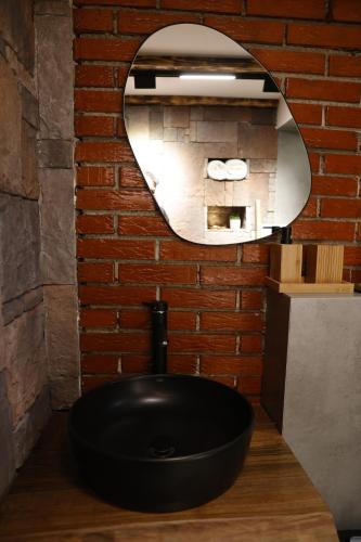 普里什蒂纳Oldtown Apartment in Prishtina的浴室设有黑色水槽和镜子