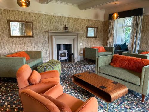 怀特黑Moresby Hall Country House Hotel的带沙发和椅子的客厅以及壁炉