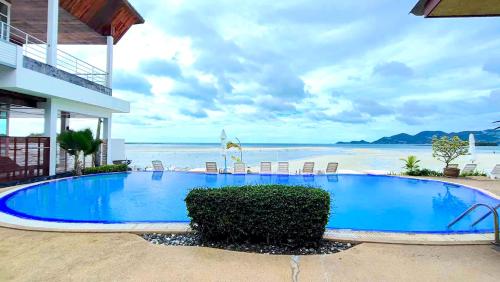 查汶Smile Samui Chaweng Beach Resort的海滩旁的大型蓝色游泳池