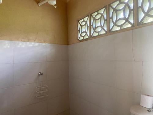 伊塔卡雷Casa Vila Camboinha的带淋浴的浴室和窗户。