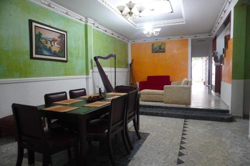 圣何塞德尔瓜维亚雷Hostal Castañeda的一间带桌椅和沙发的用餐室