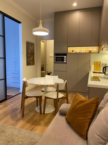阿拉木图Cozy Urban Retreat的厨房以及带桌椅的起居室。