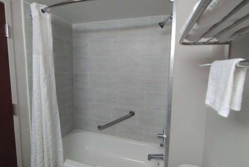 达尼亚滩Super 8 Motel by Wyndham near Fort Lauderdale Arpt的设有带白色浴缸的淋浴的浴室