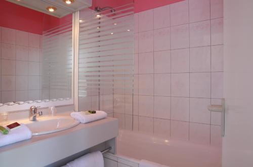 霍农LOGIS Le Pot D'Etain的一间带水槽、浴缸和镜子的浴室