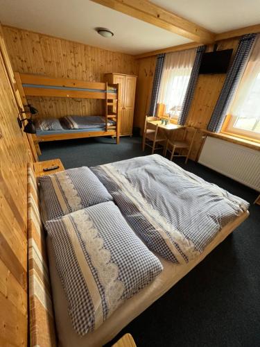 派克波特斯耐兹库Penzion Bílá Labuť的木制客房内的一间卧室,配有一张床