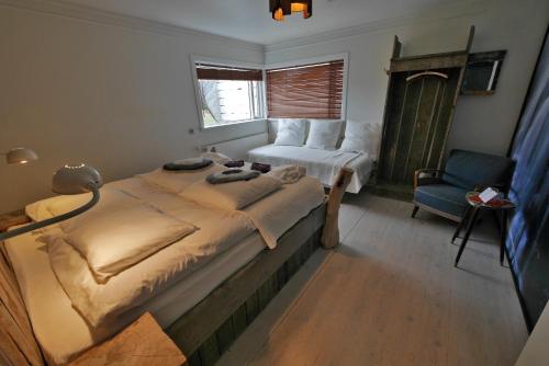 凯夫拉维克1X6旅馆的一间卧室配有一张大床和一把椅子