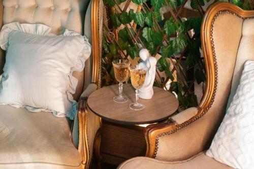 萨拉热窝Reina Spa的一张桌子,椅子上放着两杯香槟