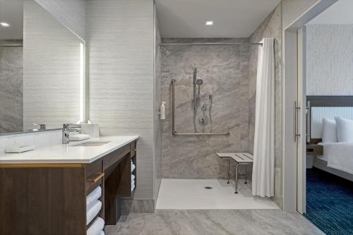 亨茨维尔Home2 Suites By Hilton Huntsville的带淋浴和盥洗盆的浴室