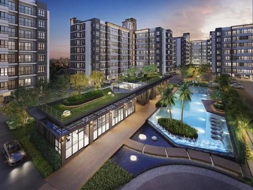 Ban Khlong Samrongsupalai city resort的享有带游泳池的建筑的空中景致