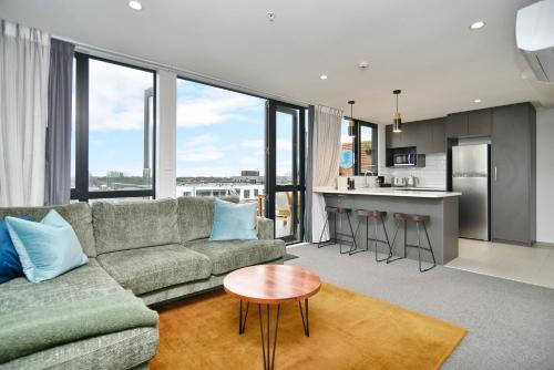 基督城Latimer Loft - Christchurch Holiday Homes的客厅配有沙发和桌子