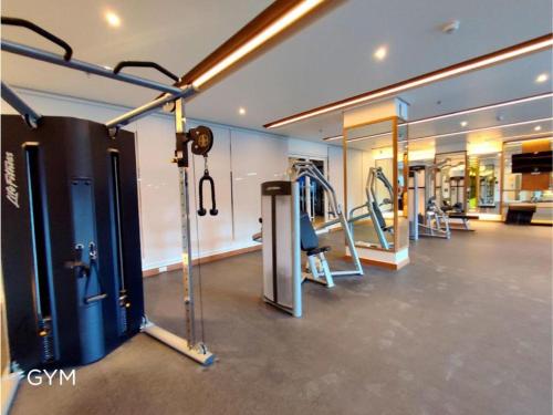 马尼拉1BR Prisma Residences DMCI Stylish Condo的一间健身房,里面配有跑步机和机器
