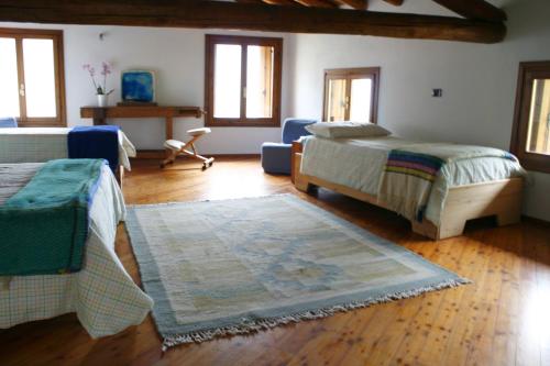 Valstagna阿罗斯皮索住宿加早餐旅馆的一间带两张床的卧室和地毯