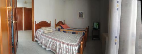 托莱多Habitación Privada Doble Toledo的一间带两张床的卧室和一台电视