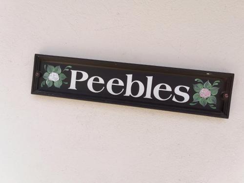 克拉伦斯Peebles Cottage的墙上读鹅卵石的标志