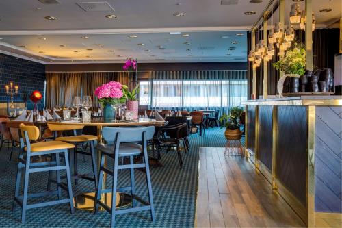 波多博德丽笙布鲁酒店的一间带桌椅的餐厅和一间酒吧