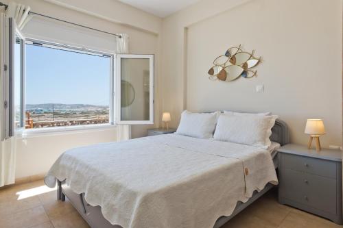 卡尔帕索斯Vènto villa的一间卧室设有一张大床和一个大窗户