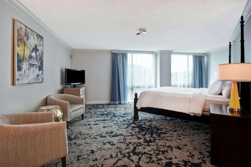 蒙哥马利蒙哥马利会议大使套房酒店的配有一张床和一把椅子的酒店客房
