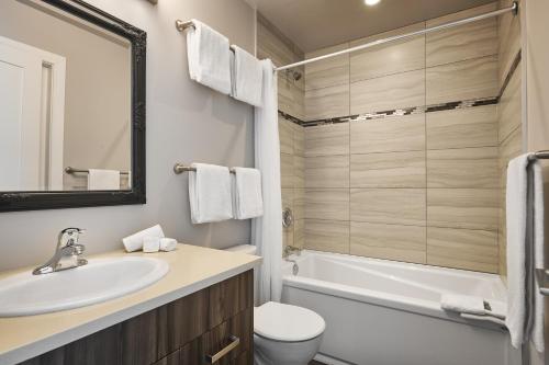 维多利亚SoLo Suites的浴室配有盥洗盆、卫生间和浴缸。