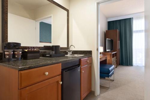 布雷亚希尔顿合博套房酒店 - 北奥兰治县的酒店客房设有水槽和镜子