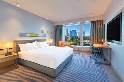 珀斯Doubletree By Hilton Perth Waterfront的酒店客房设有一张床和一个大窗户