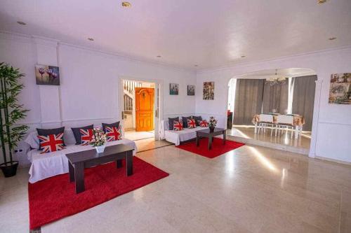 阿尔豪林德拉托里lujosa villa en Alhaurin de la Torre 7 dormitorios的客厅配有两张沙发和红色地毯