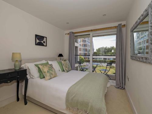 泰晤士河畔金斯顿Pass the Keys Stylish comfortable apartment in central Kingston的卧室配有白色的床和窗户。