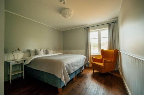 奥泰佩Väike-Juusa külaliskorter的卧室配有床、椅子和窗户。