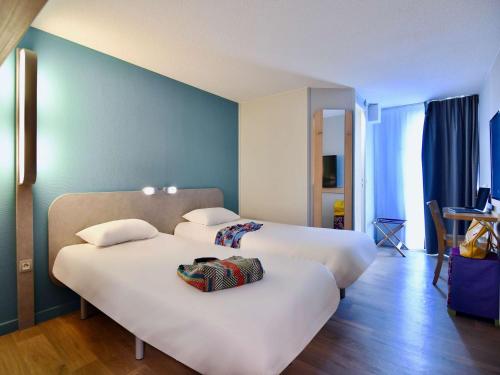 瓦讷瓦纳宜必思快捷酒店的酒店客房,配有两张带白色床单的床