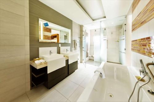 开普敦开普顿上东区希尔顿逸林酒店的带浴缸、水槽和浴缸的浴室