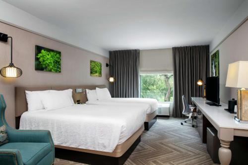 莫比尔莫比尔市中心希尔顿花园酒店的酒店客房配有两张床和一张书桌