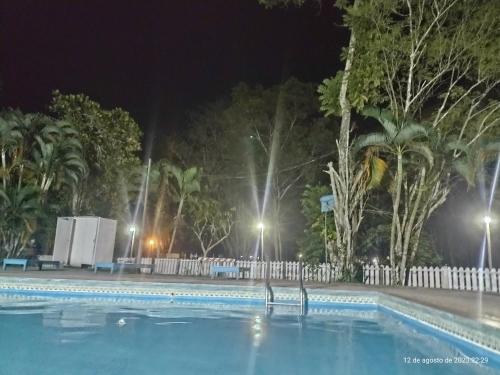 普卡尔帕Lodge del Abuelo - Divina Montaña的夜间游泳池,有树木和灯光
