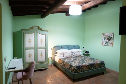 维泰博Relais Santa Caterina Hotel的一间卧室配有一张床、一个橱柜和一张书桌