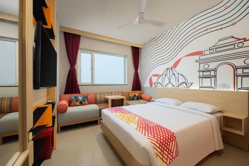新德里姜东德里酒店的卧室配有一张床,墙上挂有绘画作品