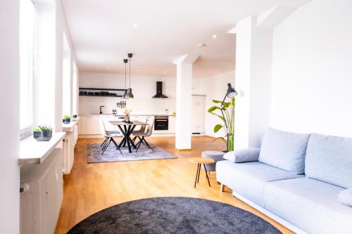 梅明根stycoz - Modernes Loft - 80 m2 - Küche - Parken的一间带白色沙发的客厅和一间厨房