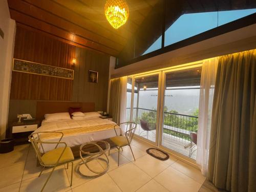 KakkadampoyilBoulevard Resorts的一间卧室设有一张床和一个阳台