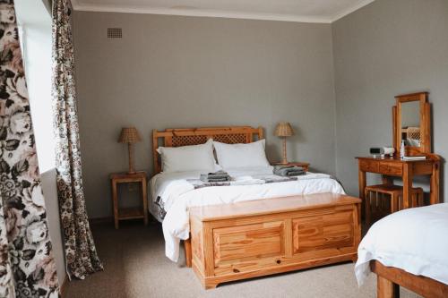 加里尔普达姆Ruigtevallei Lodge的一间卧室设有一张大床和两个床头柜