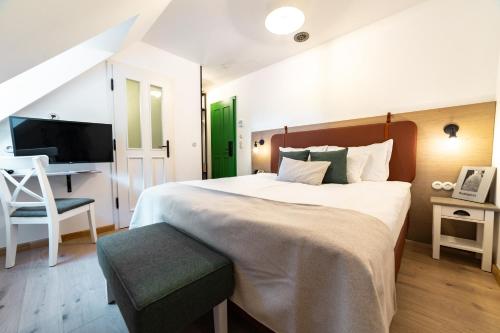 布达佩斯Czakó Bed&Breakfast的一间卧室配有一张大床和一把椅子