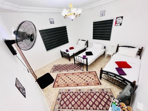 瓦迪穆萨Desert Moon的客厅配有两张沙发和一个风扇