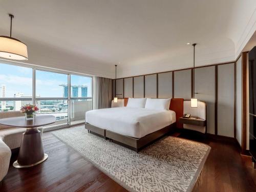 新加坡Fairmont Singapore的一间卧室设有一张大床和一个大窗户
