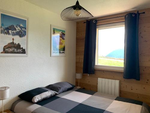 萨莫安斯Samoens 1600, ski au pied的一间卧室设有一张床和一个大窗户