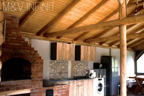 SălătrucelM&V Infinit的厨房配有砖炉和砖墙