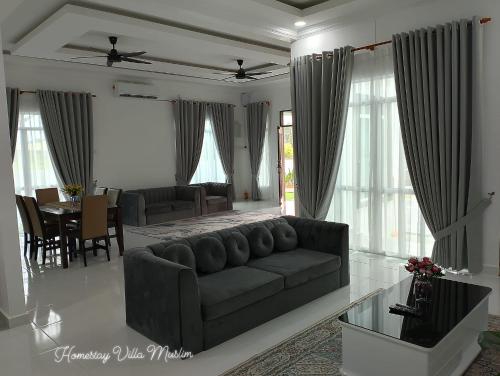 瓜拉丁加奴Homestay Villa Muslim Kuala Terengganu with pool and parking的客厅配有沙发和桌子