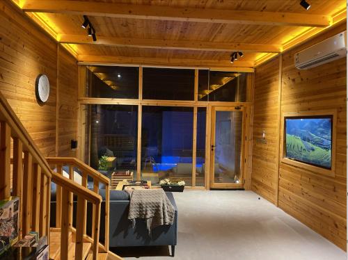 Khalij Salmanأكواخ البحيرات的客厅设有木墙和大窗户