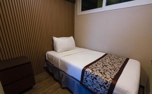 克拉克Xenia Hotel Clark的一间小卧室,配有一张床和一个枕头