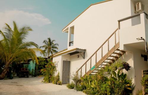 VashafaruMy House的白色的建筑,有楼梯和棕榈树